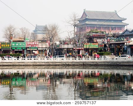 Beijing, China - March 26, 2015: Morning Mist Over Houhai Lake With Drum Tower And Bell Tower At The