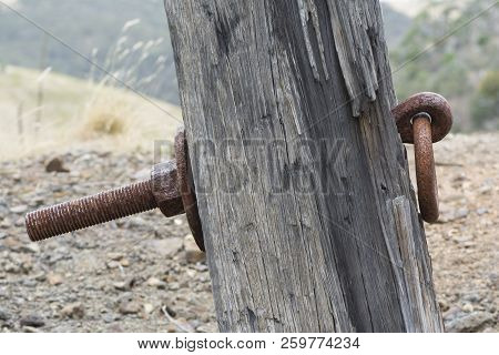 Rusting Metal Ring Attached To An Old Sleeper With A Thick Metal Pin And Bolted To The Back. Found A