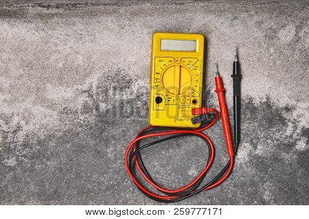 Diy Home Electricity Working Tools Concepts, Old Yellow Multi Meter On Dusty Cement Background With 