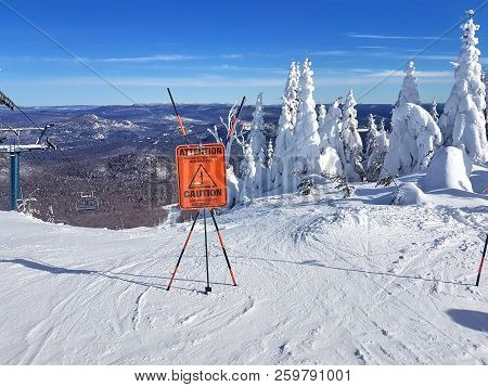 Caution Sign And Warning On A Ski Resort About Unmarked Rocks And Obstacles In The Beginning Of A Tr