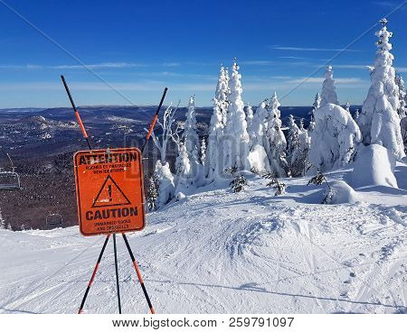 Caution Sign And Warning On A Ski Resort About Unmarked Rocks And Obstacles In The Beginning Of A Tr