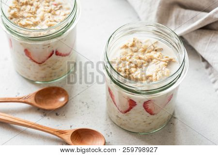 Overnight Oats Or Oatmeal In A Jar On Concrete Background. Healthy Eating, Healthy Lifestyle Concept