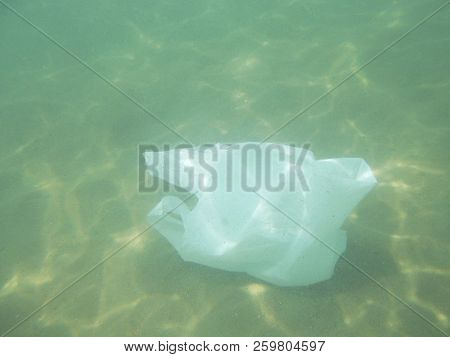 Plastic Bag Floating Into The Sea. Polluted Enviromental. Recycle Garbage