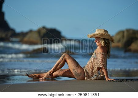 young woman relaxing on the beach in summer day