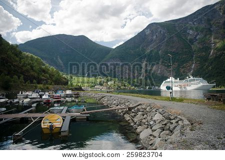 Aurlandsfjord, Flam, Norway - 27 July, 2018: Cruise Liner And Boats Moored Near Majestic Mountains A