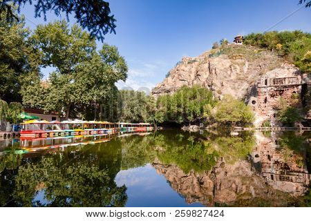Water boats on pond at Hong Shan (Hongshan or Red Mountain) park in Urumqi, Xinjiang, China