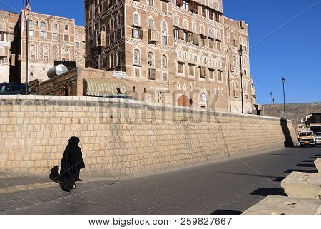 Sanaa, Yemen - March 13, 2010: Two Women In A Black Burka Burqa Walking Down A Street In Sanaa