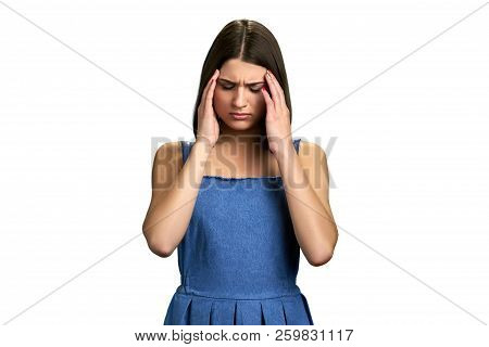 Tired Girl Suffering From Migraine. Young Pretty Woman Touching Her Temples With Closed Eyes Because