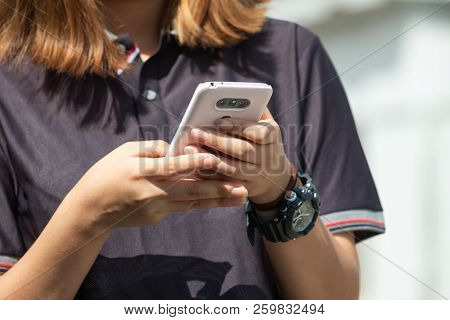 On The Photo The Hands Of The Girl Who Is Calling On The Phone.