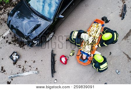 An Injured Woman In A Plastic Stretcher After A Car Accident, Covered By Thermal Blanket.