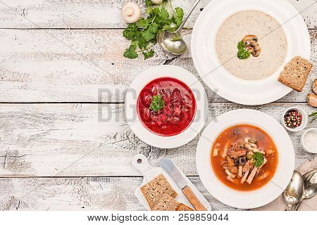 Set Of Three Bowls With Different Soups: Meat Soup Solyanka, Russian Borsh And Mushroom Cream Soup O