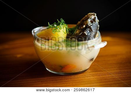 Vegetable Soup With Fish In A Glass Bowl