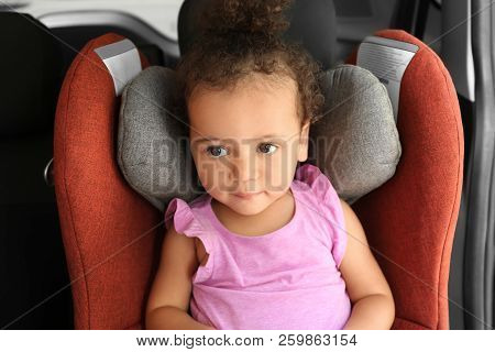 Little African-american Girl In Child Safety Seat Inside Of Car