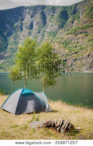Tourist Tent And Stack Of Firewood In Camping Near Beautiful Aurlandsfjord, Flam Aurlandsfjorden , N