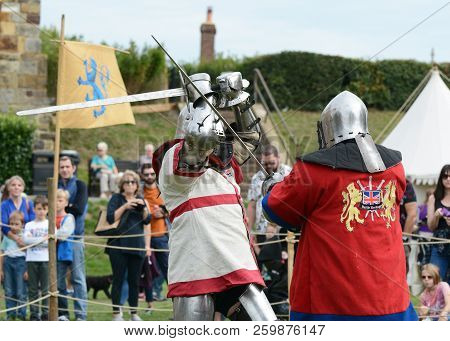 Two Knights In Medieval Battle Dress Fight With Swords