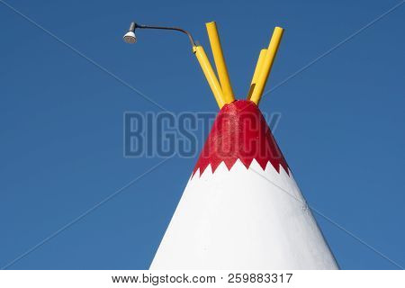 Top Half Abstract View Of A Wigwam Structure Made Of Concrete And Rebar. Painted Red White And Yello