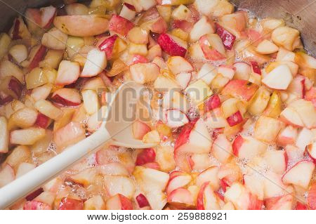 Cook Apple Jam And Stir With A White Plastic Spoon. Process Of Making Apple Jam Marmalade At Home