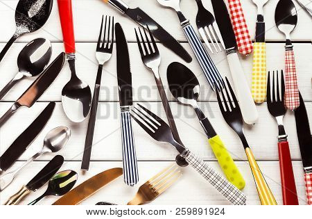 Top View On Various Forks, Knives And Spoons. Set Of Assorted Cutlery With Fancy Handles, Flat Lay O
