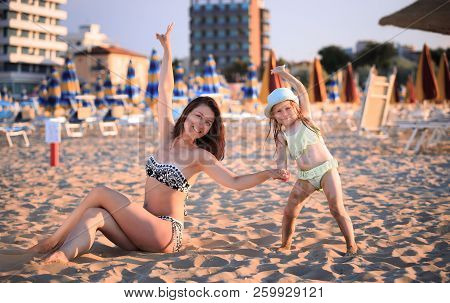 Beach Scene. Happy Woman And Child On Beach Sand In Rimini. Summer Vacation Scene.