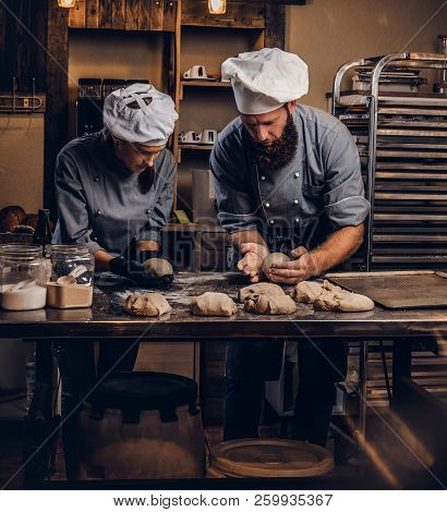 Chef Teaching His Assistant To Bake The Bread In A Bakery.