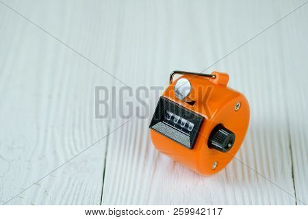 Tally Counter Or Counting Machine With 0000 Number On White Wooden Table, Business And Finance Conce