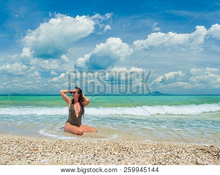 woman sunbathing on the beach summer travel holidays