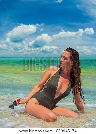 woman sunbathing on the beach summer travel holidays