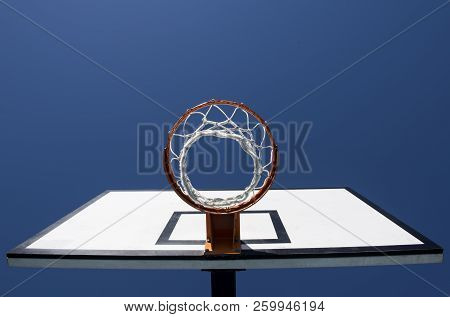 Basketball Hoop And Backboard Set Against Blue Sky