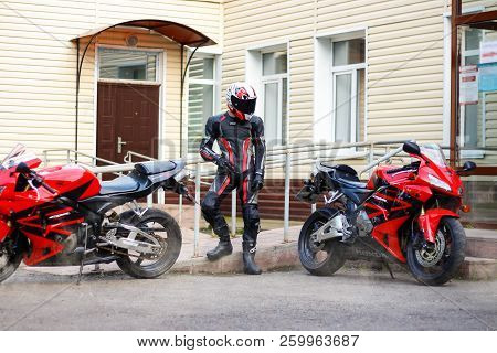 Krasnoyarsk, Russia - September 08, 2018: Beautiful Motorcyclist In Full Gear And Helmet And A Two R