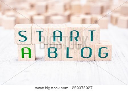 The Words Start A Blog Formed By Wooden Blocks On A White Table
