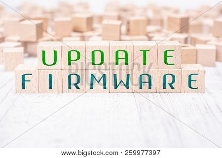 The Words Update Firmware Formed By Wooden Blocks On A White Table