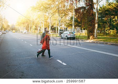 Young Cheerful Couple In Love, Smiling Woman Man In Casual Warm Clothes Walking By Hands Looking Bac