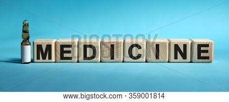 Medicine - Word On Cubes. Drug In Ambula To Reduce Disease Symptoms On A Blue Background