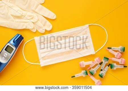 Virologist Tools - Medical Mask, Surgical Gloves, Infrared Thermometer, Scarifier, Flat Lay, Medical