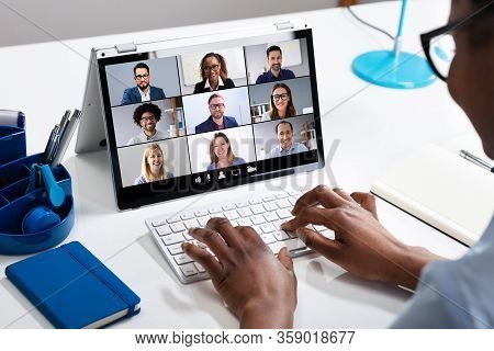 Woman Working From Home Having Group Videoconference On Laptop
