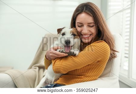 Young Woman With Her Cute Jack Russell Terrier At Home. Lovely Pet