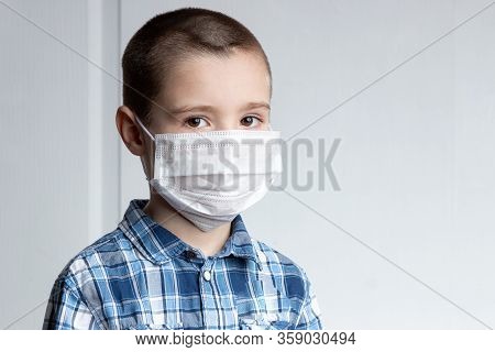 Young Boy With Sore Eyes In A Medical Mask Look At Camera. Medical Protection Against Airborne Disea