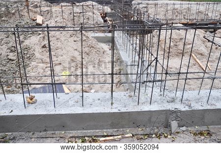 Building The Brick House Concrete Foundation With A Rigid Structure Of Reinforcing Iron Bars.