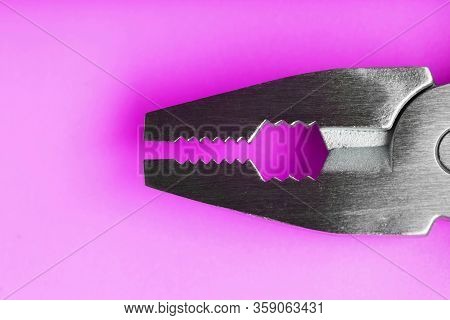 Multitool Is A Multi-functional Tool On A Pink Background. The Concept Of An Open, Flying Multi-tool