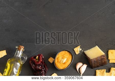 Almogrote , Cheese Paste With Their Ingredients Hard Cheese, Peppers, Olive Oil And Garlic On Black 