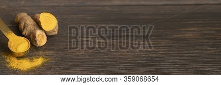 Turmeric Root, Turmeric Powder On Wooden Large Background For Banner. Curcuma Used As For Food And T