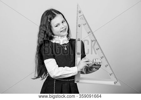 Girl With Big Ruler. School Student Study Geometry. Sizing And Measuring. Kid School Uniform Hold Ru