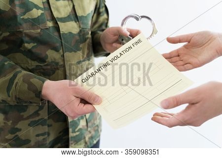 Police Officer With Handcuffs In Khaki Colored Uniform Stops People On The Street For Violating Rule