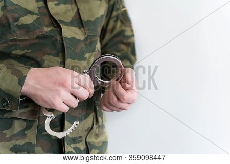 Police Officer With Handcuffs In Khaki Colored Uniform Stops And Arrest Criminal On The Street For V