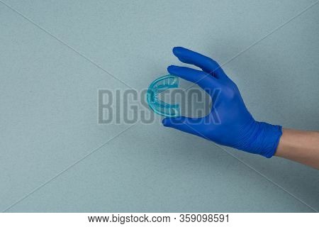 Myofunctional Trainer For Correction Of Bite And Alignment Of Teeth In The Hand Of Doctor In The Glo
