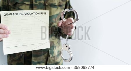 Police Officer With Handcuffs In Khaki Colored Uniform Stops People On The Street For Violating Rule