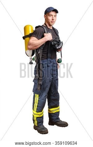 Young Fireman In Baseball Cap With Respirator And Air Breathing Apparatus On His Back In Protective 