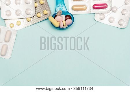 Medicine Pills On On Blue Backdrop. Different Color Pills Of Drugs And Medicines. Copy Space