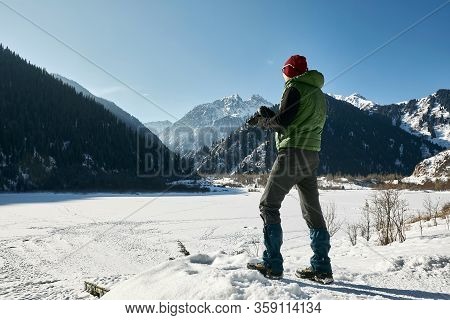 Travel Photographer Man In Mountain Winter Landscape, Almaty, Kazakhstan