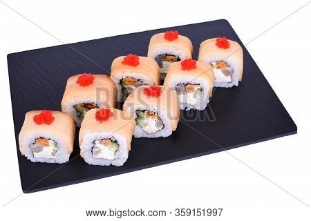 Traditional Fresh Japanese Sushi Rolls On A Black Stone Mikado On A White Background. Roll Ingredien